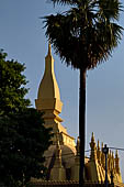 Vientiane, Laos - Surrounded by a cluster of pointed minor stupas the huge Pha That Luang shined under the warm light of the sunset. 